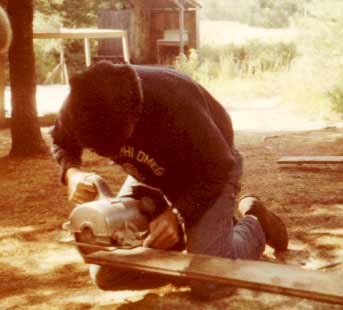 Joe Haebler trying to saw some planks. Joe's work improved 